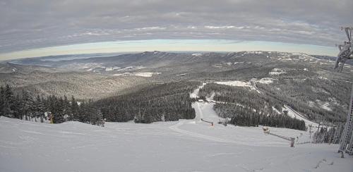 a snow covered mountain with a ski lift at Apartmán KK in Zwiesel