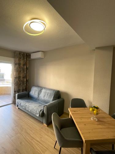 a living room with a couch and a table at DARISOL in Santa Pola