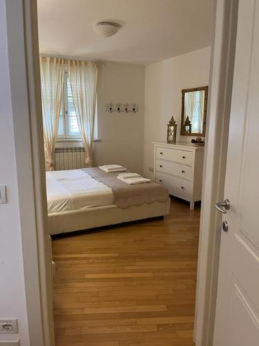 a bedroom with a bed and a dresser and a mirror at Il Borgo in Trieste