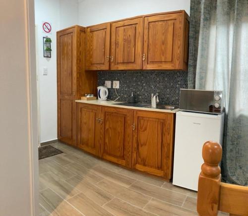 a kitchen with wooden cabinets and a white refrigerator at Dome Home Accommodation in Nelspruit