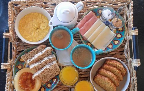 a tray of food with different types of bread and dips at Revolucionarte.Potrerillos in Potrerillos