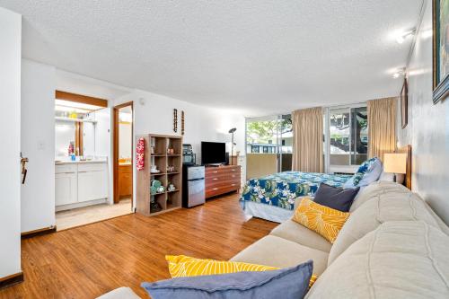 a living room with a couch and a bedroom at @ Marbella Lane -Coastal retreat near Diamond Head in Honolulu