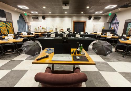a conference room with a table with a laptop on it at Norweska Dolina Family&Pet-friendly Resort in Szklarska Poręba