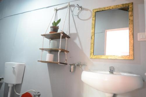 a bathroom with a sink and a mirror at GoYm Resort in Arambol