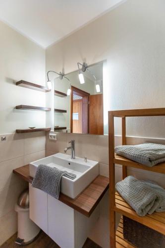 a bathroom with a sink and a mirror at Ferienwohnung Wattkönig in Wyk auf Föhr