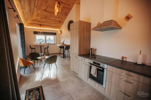 a kitchen with a counter and a dining room at # A Mont Nos'Hôtes in Malmedy