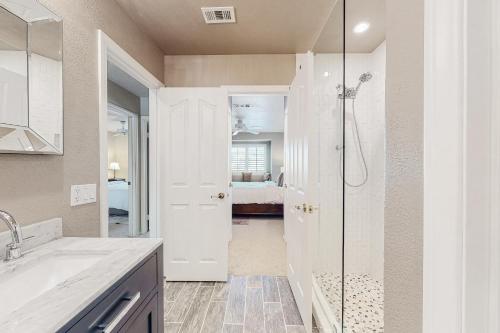 a bathroom with a shower and a sink at Carlotta Haven in Palm Desert