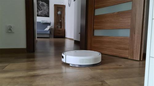 a white toaster sitting on the floor next to a door at Spokojny Wypoczynek 5 in Ostrów Wielkopolski