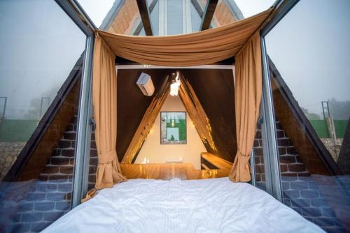 a bedroom with a bed in a tent at Lost in Sky in Yenokavan