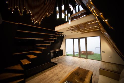a room with stairs and a table and a large window at Lost in Sky in Yenokavan