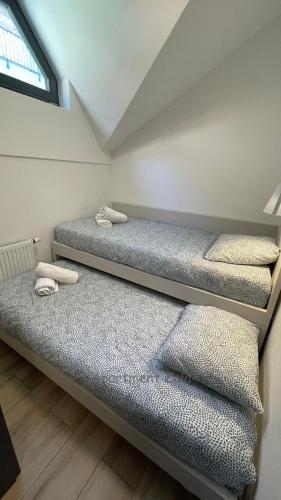 three bunk beds in a room with a window at Apartma Zala, Golte in Mozirska Koča