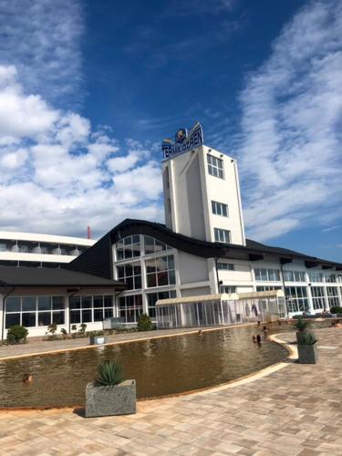 a large white building with a sign on top of it at Hotel Terme Ozren in Bosansko Petrovo Selo