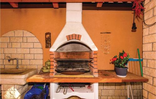 a brick oven on a counter in a kitchen at 2 Bedroom Gorgeous Apartment In Kostrena in Kostrena