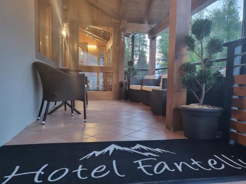 a hotel room with a hotel fence sign on a rug at Hotel Fantelli in Folgarida