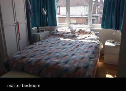 a bedroom with a bed and a window at Double Rooms in Shared Home in Enfield