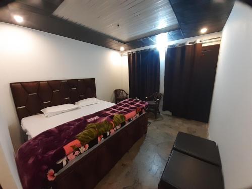 a bedroom with a large bed in a room at Lake Haven Resort, Sari, Chopta in Sari