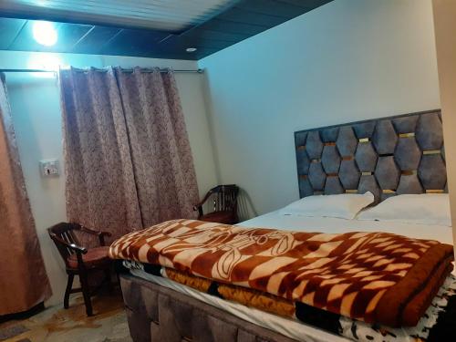 a bedroom with a large bed with a wooden headboard at Lake Haven Resort, Sari, Chopta in Sari