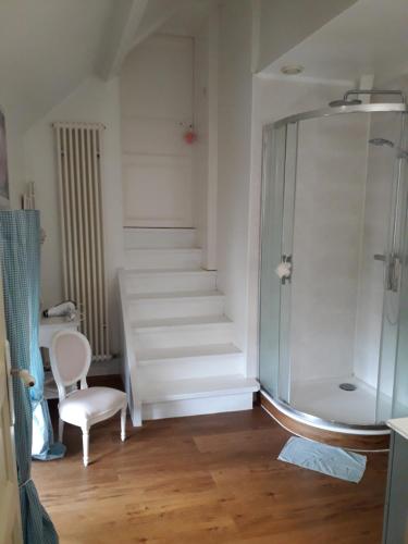 a bathroom with a glass shower and a staircase at Château de varaize in Varaize