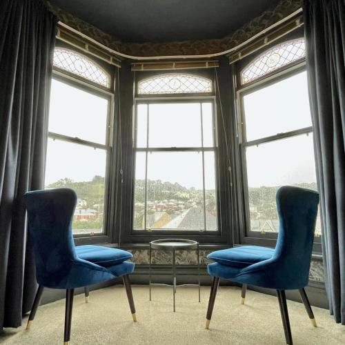 two chairs and a table in front of a window at The Earlsdale Bed and Breakfast in Ilfracombe