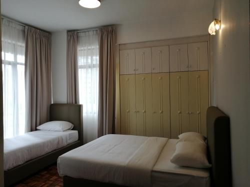 a bedroom with two beds and a large closet at City Tropical Home I in George Town