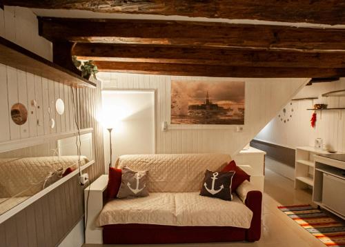 a bedroom with a bed and a couch with pillows at Residenza Biennale Apartment in Venice