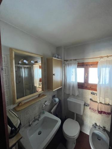 a bathroom with a white sink and a toilet at Sèn jan apartment 150 mt dalle piste in Pozza di Fassa