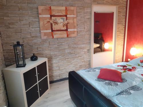 a bedroom with a bed with a red pillow on it at Im Vulkanland Fewo bis 6 Personen in Ettringen
