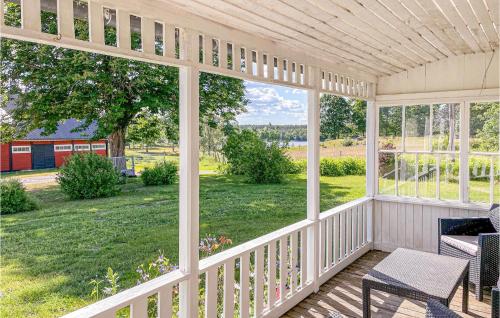 a screened in porch with a view of the yard at Stunning Home In Karlskrona in Karlskrona
