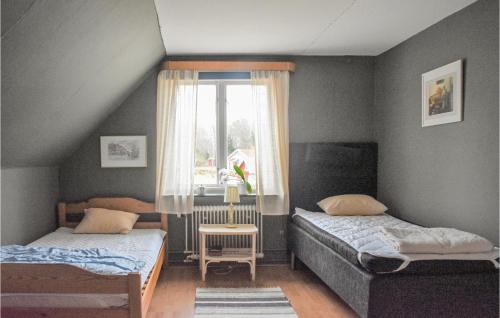 a bedroom with two beds and a window at Awesome Home In Karlskrona With Wifi And 3 Bedrooms in Karlskrona