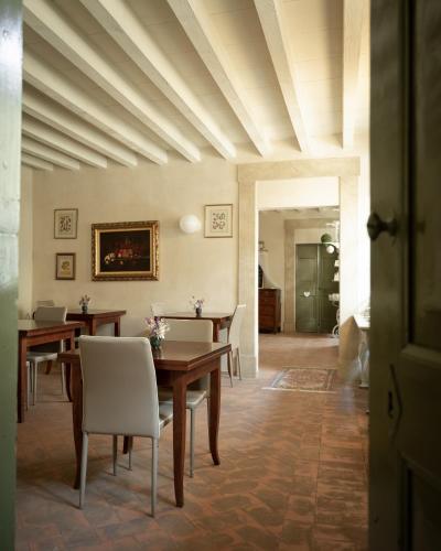 a dining room with tables and chairs and a ceiling at Hotel Palazzo Novello in Montichiari