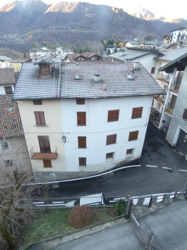 a large white building with a mountain in the background at La dimora degli Angeli in Moggio