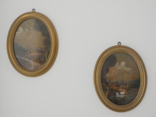 two framed paintings hanging on a wall at La dimora degli Angeli in Moggio