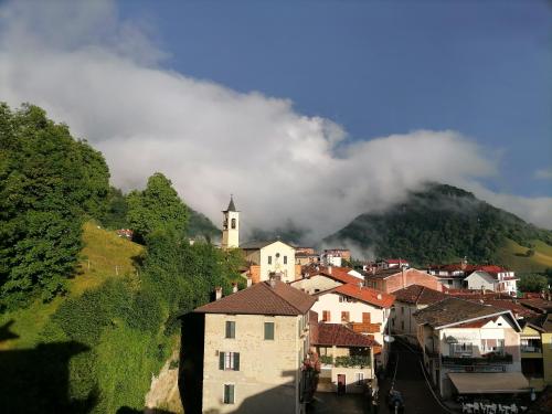 a small town with a church and a mountain at La dimora degli Angeli in Moggio