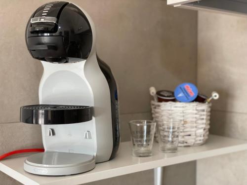 a coffee maker is sitting on a shelf at Aurelia Sweet House in Rome