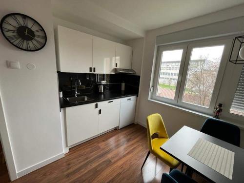 a kitchen with a sink and a table with chairs at FOUR PEARLS in Karlovac