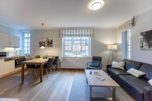 a living room with a couch and a table at Villa Friedericia in Wyk auf Föhr