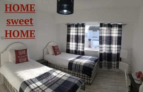 a bedroom with two beds and a window at excessivEDemand home in Thorne