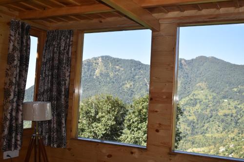 a window in a room with a mountain view at Bagar Trails in Nainital