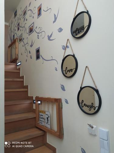 a staircase with two mirrors on the wall at Agapi's Two Levels Studio in Athens