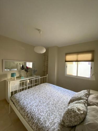 a bedroom with a bed and a window at Los Menceyes Yaral in Candelaria