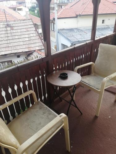 a balcony with two chairs and a table and a table and chairs at Holiday at the Baščaršija in Sarajevo