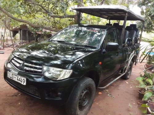 a black pick up truck with a canopy on top at mango villa wilpattu in Nekattegama