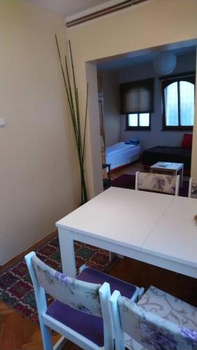 a living room with a white table and chairs at Holiday at the Baščaršija in Sarajevo