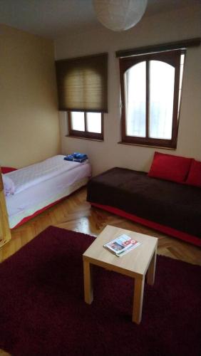 a living room with two beds and a coffee table at Holiday at the Baščaršija in Sarajevo