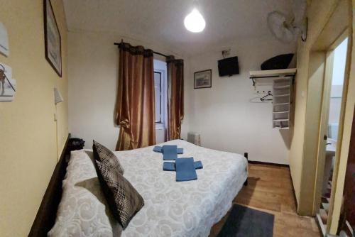 a bedroom with a bed with blue cards on it at Pensao Residencial Flor dos Cavaleiros in Lisbon