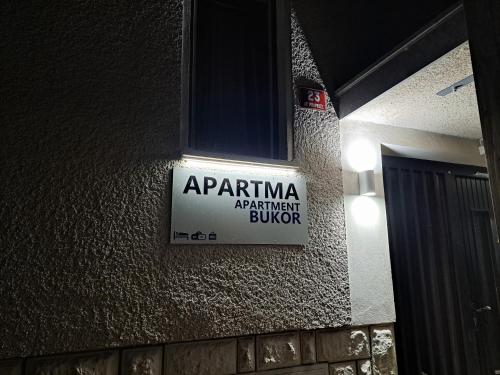 a sign on the side of a building at Apartments Bukor with seasonal pool in Lukovica pri Domžalah