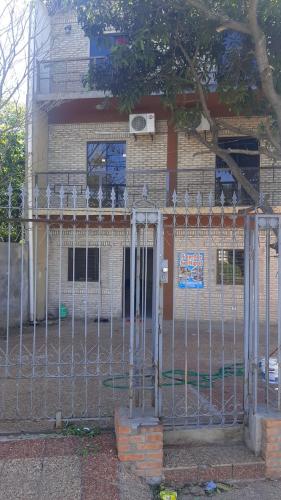 a metal fence in front of a building at Hospedaje San Miguel in Luque