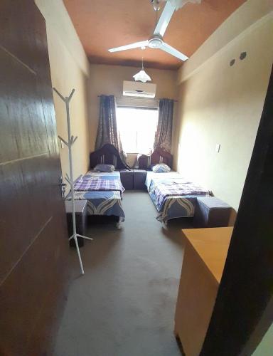 ein Zimmer mit 2 Betten und einem Sofa darin in der Unterkunft Hospedaje San Miguel in Luque