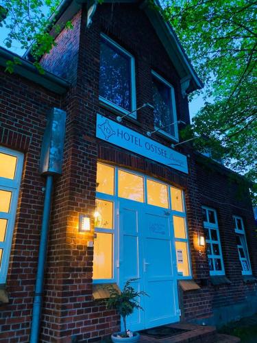 a brick building with a blue door and a hotel outside at K 357 - Low budget Hotel in Ratekau bei Lübeck in Ratekau