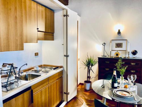 a small kitchen with a sink and a table at La Mandorla studio apartment in Piazza del Duomo in Florence